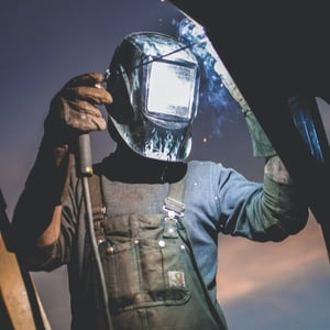Young adult welding 